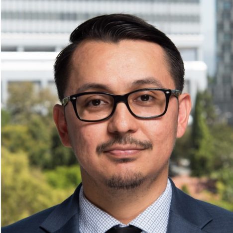 Eduardo with dark-rimmed glasses